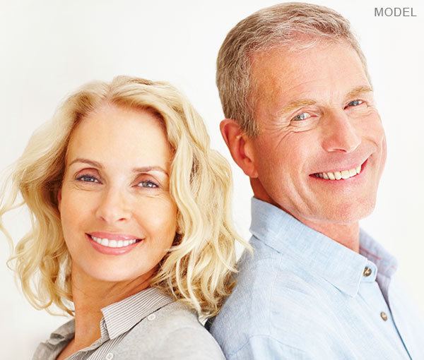 Male and female model standing back to back