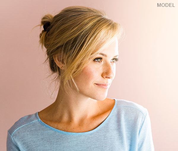 Female model looking out window smiling
