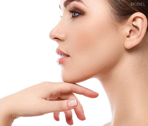 Model propping up chin with hand