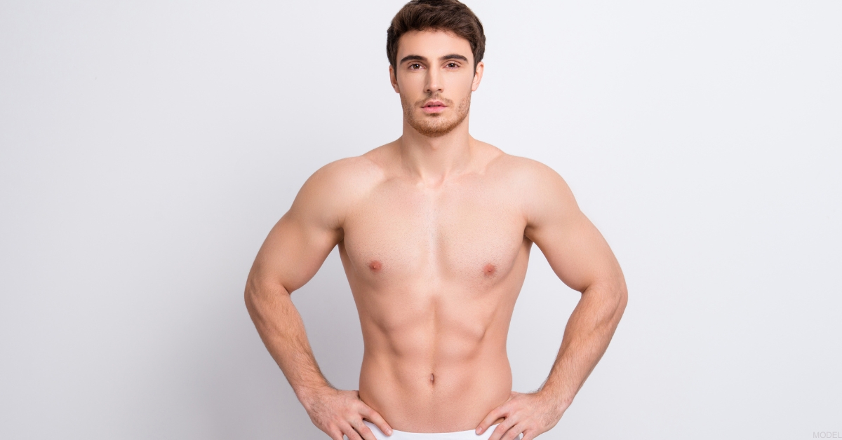 Fit man with his hands on his hips (model)